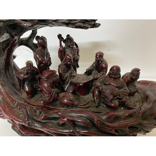 918 - Oriental style carving depicting Buddhas in garden scene. Very heavy measuring 40 x 25 cms