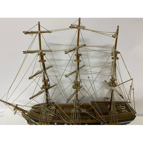 930 - A model of a three masted sailing ship measuring 64 cms long