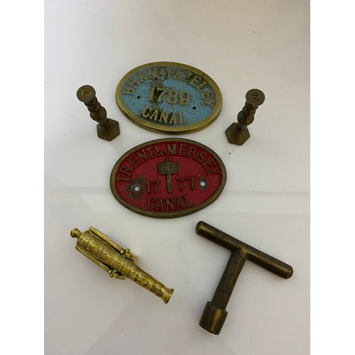 25 - Collection of brassware including railway signs, miniature cannon, belt buckles, candlesticks etc