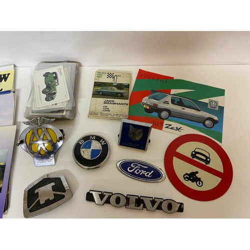 28 - Box of automobilia including car badges, postcards, booklets etc