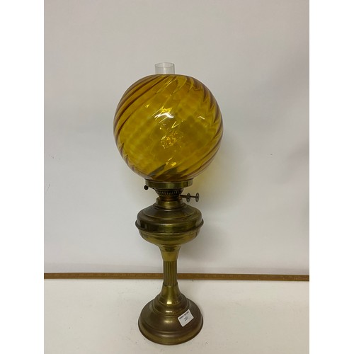 201 - Brass paraffin lamp complete with glass shade and funnel measuring 58 cms tall