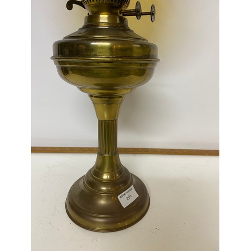 201 - Brass paraffin lamp complete with glass shade and funnel measuring 58 cms tall