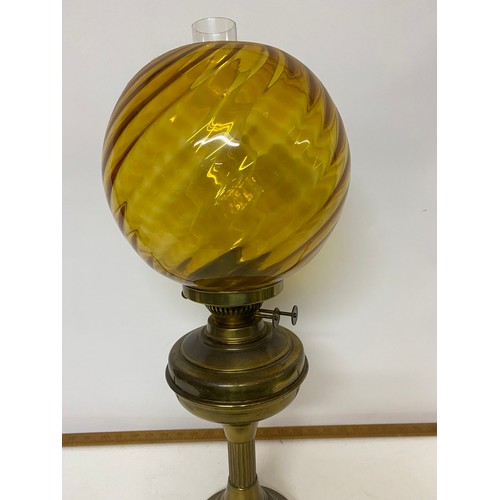 201 - Brass paraffin lamp complete with glass shade and funnel measuring 58 cms tall