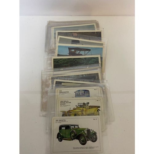 28 - Box of automobilia including car badges, postcards, booklets etc