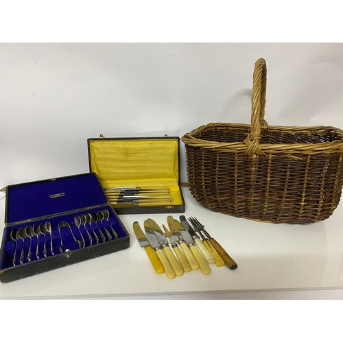 353 - Vintage Wicker shopping basket with selection of loose cutlery, box set of knives and boxed set of t... 