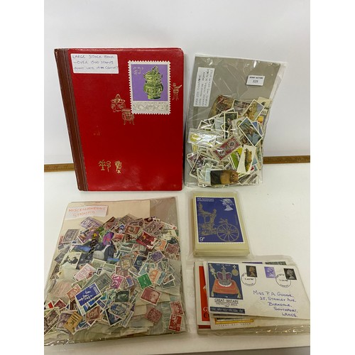 329 - Selection of stamps, cigarette cards, first day covers and postcards.