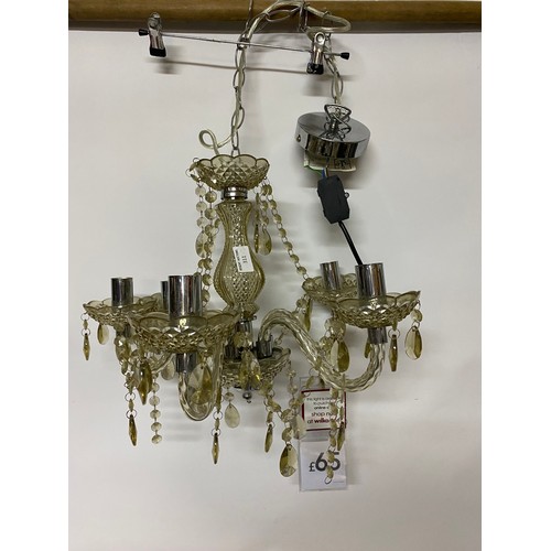 311 - A clear 5 arm plastic chandelier measuring 34 cms tall