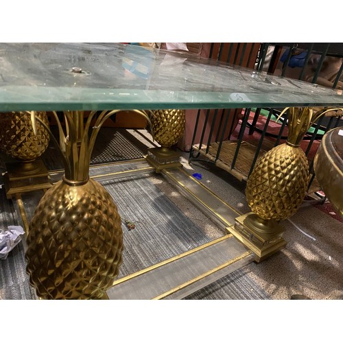 439 - Coffee table in glass and gold tone metal with pineapple legs. Measuring 70 cms square. Missing nuts... 