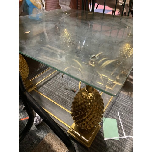 439 - Coffee table in glass and gold tone metal with pineapple legs. Measuring 70 cms square. Missing nuts... 