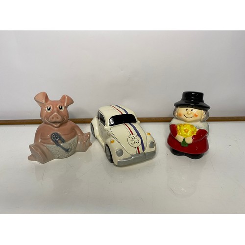 607 - Collection of retro money boxes including Nat West Pigs and Herbie, all with stoppers.