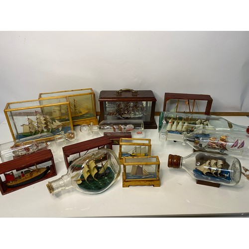 672 - Selection of glass boats in bottles and glass cases