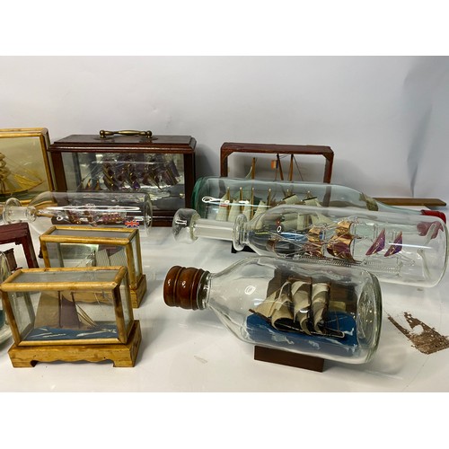 672 - Selection of glass boats in bottles and glass cases