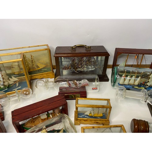 672 - Selection of glass boats in bottles and glass cases