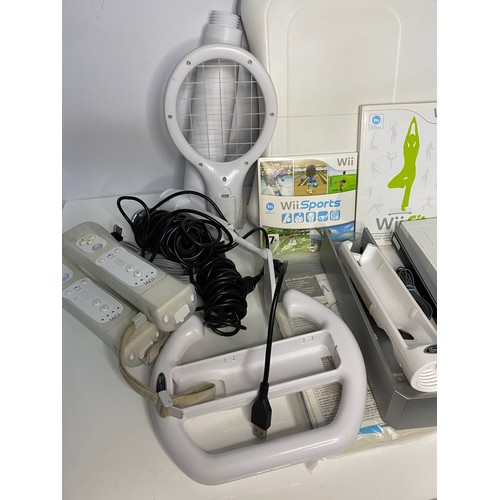 175 - Nintendo Wii console with games and accessories including Fit Board, sports, music, games and microp... 