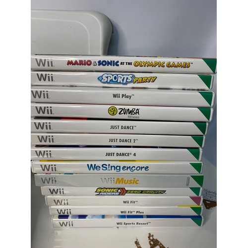 175 - Nintendo Wii console with games and accessories including Fit Board, sports, music, games and microp... 