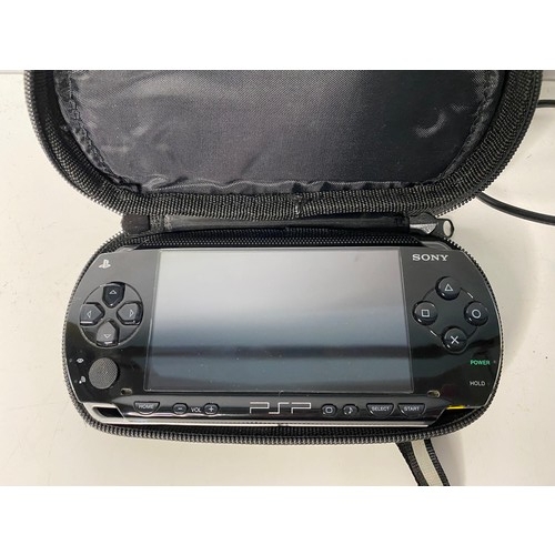 125 - Sony PSP with games and leads.