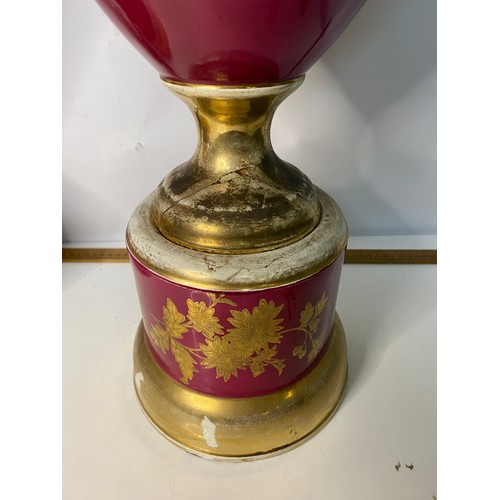 172 - Pair of large urns on pedestal bases in red and gold, some wear on gilt and damage to base, measurin... 