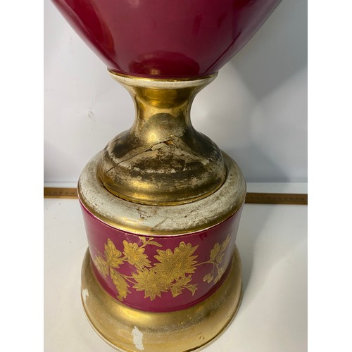 172 - Pair of large urns on pedestal bases in red and gold, some wear on gilt and damage to base, measurin... 