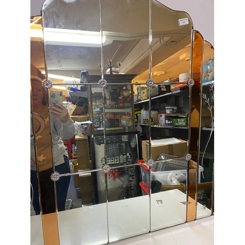 305 - A vintage art deco and peach coloured frameless mirror with bevelled panels measuring 91 cms square,... 