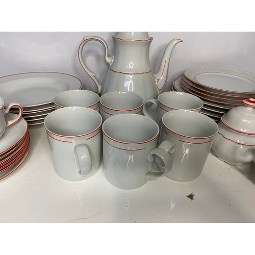 393 - 38 piece dinner service in white with red trim. Includes dinner plates, side plates, soup bowls, cup... 