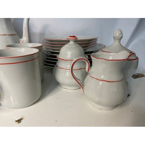 393 - 38 piece dinner service in white with red trim. Includes dinner plates, side plates, soup bowls, cup... 