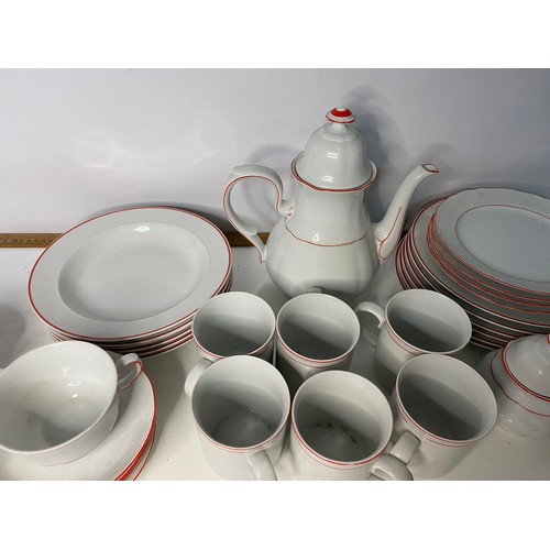 393 - 38 piece dinner service in white with red trim. Includes dinner plates, side plates, soup bowls, cup... 