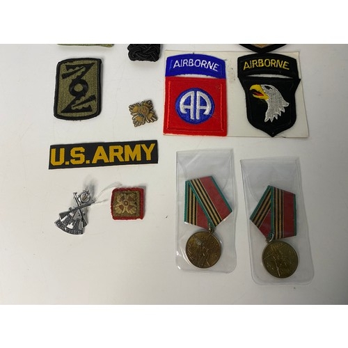 14 - Bag of military medals, badges and patches.