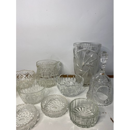 672 - Selection of glass dishes, jugs, vases and bell.