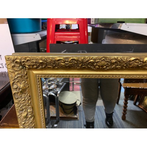 757 - Gold ornate framed bevelled mirror measuring 72 x 100 cms