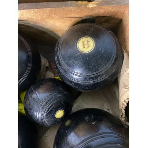 742 - Old wooden box containing vintage crown green bowls