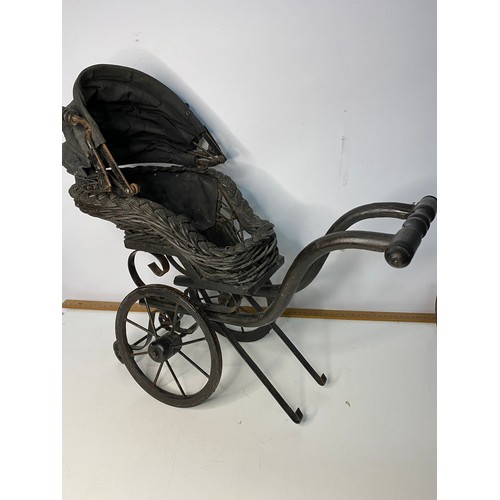 747 - Late 19th century dolls iron and canework bath chair and a dolls wicker pram with canvas hood.