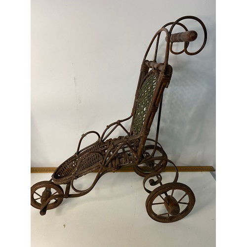 747 - Late 19th century dolls iron and canework bath chair and a dolls wicker pram with canvas hood.