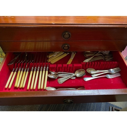 779 - Silver plate cutlery set in a 3 drawer display unit standing 59 x 72cms tall