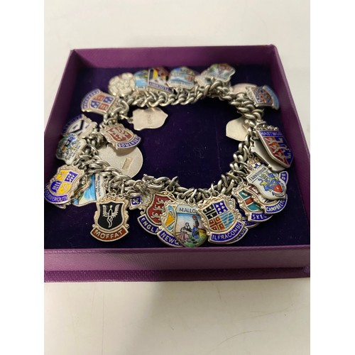 101 - Silver Charm bracelet with 36 silver and enamel town charms.