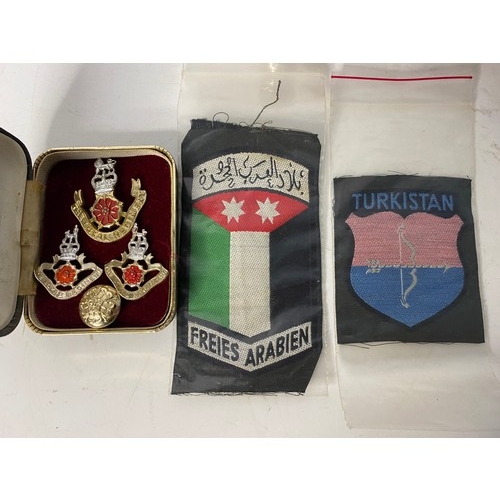 4 - Collection of militaria including badges, patches and cartridges.