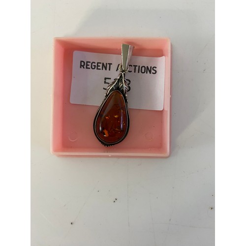 528 - Sterling silver and amber pendant.