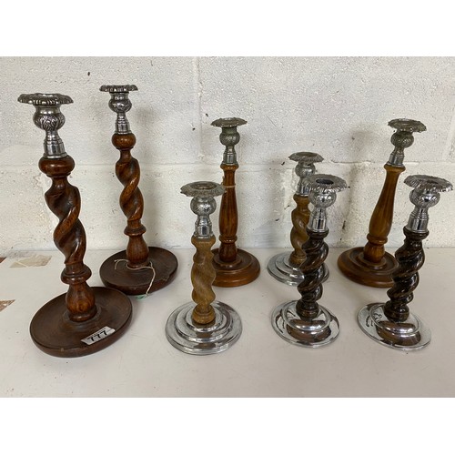 777 - 6 pairs of metal and wooden candlesticks, largest measures 31 cms