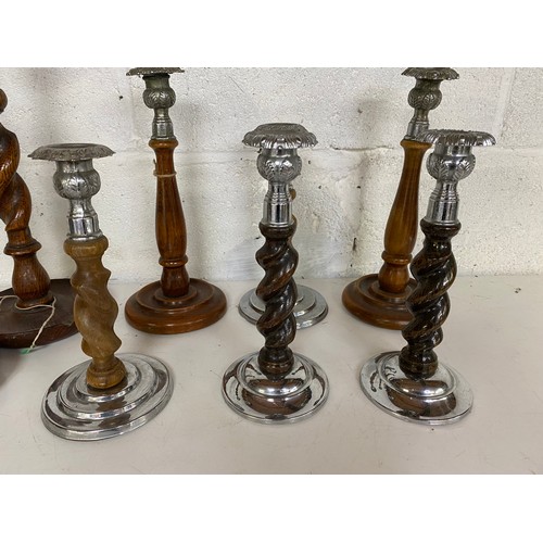 777 - 6 pairs of metal and wooden candlesticks, largest measures 31 cms