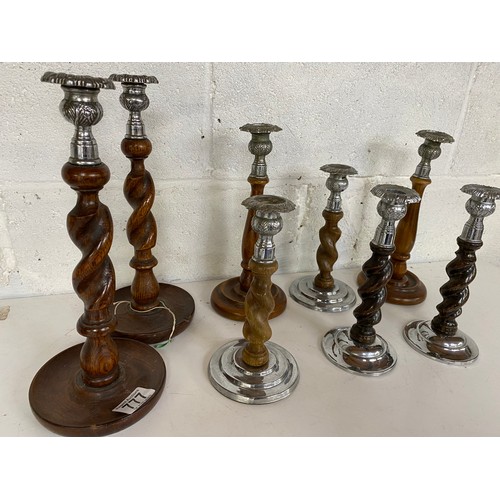 777 - 6 pairs of metal and wooden candlesticks, largest measures 31 cms