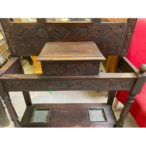 807 - Wooden carved hall stand including drip trays for umbrellas measuring 91 x 199 cms tall