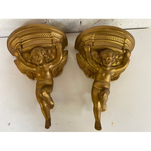 818 - Pair of gold cherub sconces measuring 31 cms tall