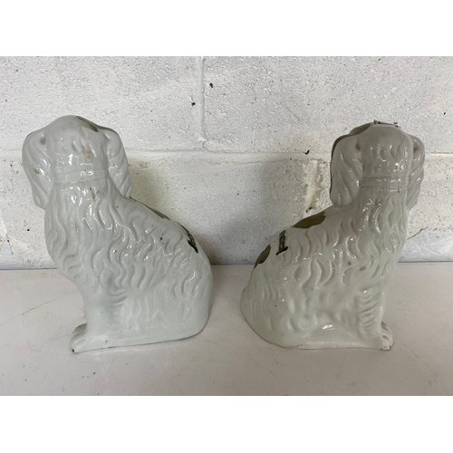 820 - Pair of mantle dogs measuring 24 cms tall