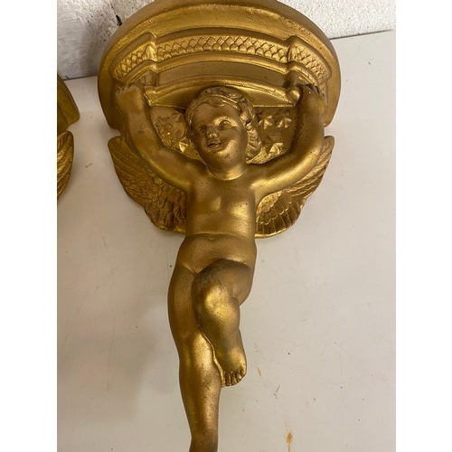 818 - Pair of gold cherub sconces measuring 31 cms tall