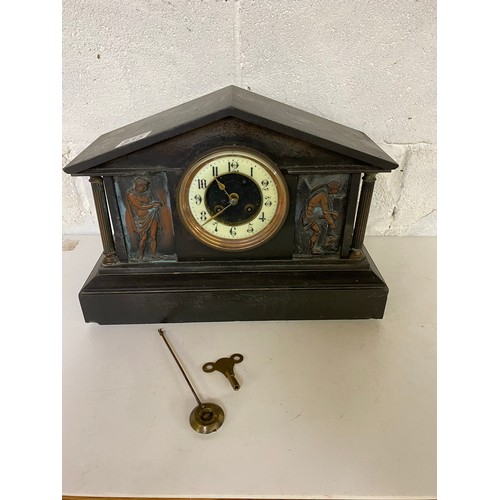 835 - A John Taylor slate/marble mantle clock with key, believed to be working, slight damage