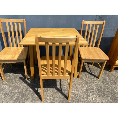 868 - Set of 3 light pine chairs and a dropleaf table. Table measures 76 x 46 cms unfolded