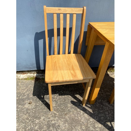 868 - Set of 3 light pine chairs and a dropleaf table. Table measures 76 x 46 cms unfolded