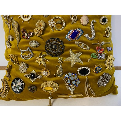 654 - Cushion of vintage brooches including several by Sarah Coventry.