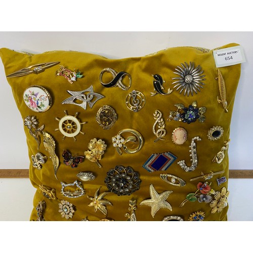 654 - Cushion of vintage brooches including several by Sarah Coventry.