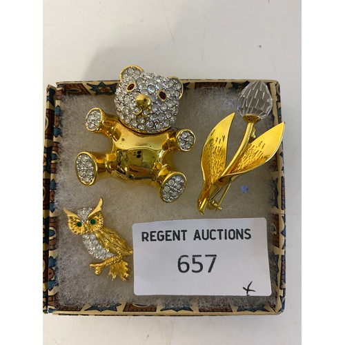 657 - A Swarovski crystal owl pin, a Swarovski crystal tulip brooch and a gold tone rhinestone teddy brooc... 