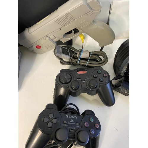 684 - Original PS2 console with controllers, racing wheel, Namco light gun and 10 games. Tested and workin... 